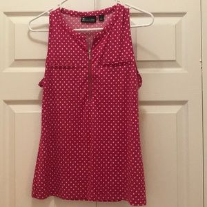 Sleeveless top. Pink with white polka dots.